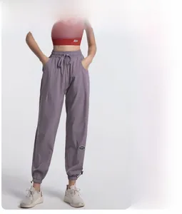 Detail of high waist joggers with adjustable drawstring and morandi purple breathable fabric