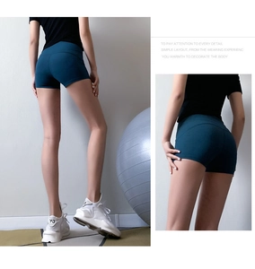 Rear view of high waisted peacock blue yoga shorts with seamless compression fit