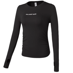 Slim fit black yoga crop top with long sleeves, thumb holes and Balance Care print