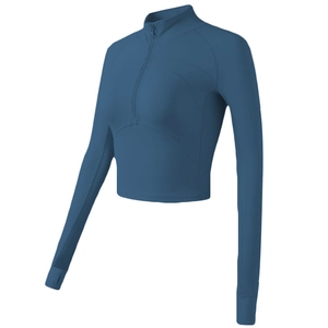 Side view of slim-fit athletic cropped top with half-zip collar and thumb holes