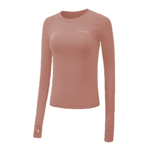 Detail of terracotta long-sleeve sports top featuring thumbholes and brand logo