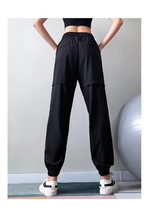 Rear view of black jogger pants featuring elastic waist and stylish knee panel stitching