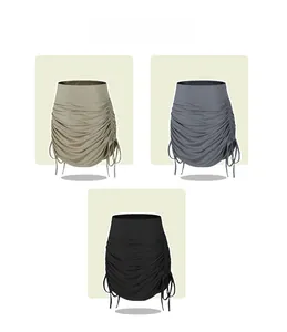 Detailed view of high-waist drawstring skirts in khaki, smoke grey, and black options