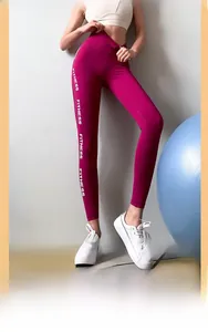Detail of high-waist fitness leggings in rose red with FITNESS print on the side