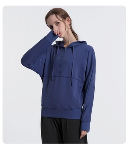Detail view of the navy blue oversized hoodie featuring a half-zip and ribbed cuffs