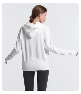 Rear view detail of loose white hoodie with drop shoulder and ribbed cuff finish