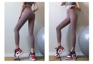 Close-up of high-waist yoga pants in dusty rose showing seamless fit and lifting effect