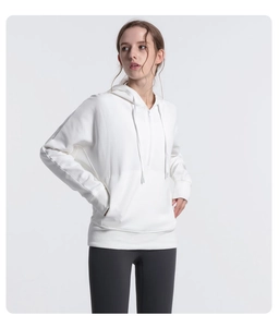 Detail of white half-zip hoodie with drawstring hood and large front pocket for fitness