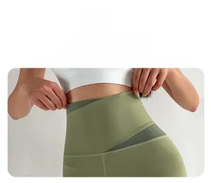 Detail of high waisted yoga leggings featuring olive and dark green contrast patchwork