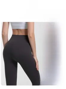 Close-up of high-waist yoga pants with charcoal grey fabric and purple patchwork cuffs