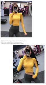 Detail of slim fit yoga top with thumbholes and high waist leggings in gym setting