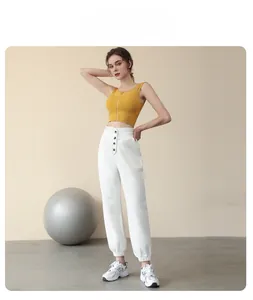 Detail view of high waist tapered joggers with button waist and elastic cuffs design