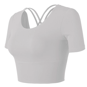 Detailed back view of white yoga top with criss-cross straps and wide elastic hem