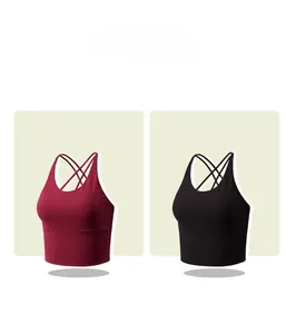 Detail view of burgundy and black criss-cross back sports bras in matte elastic fabric