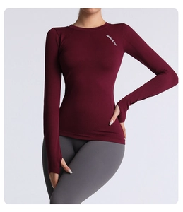 Detailed view of burgundy slim fit yoga top with thumbholes and Neverstop lettering