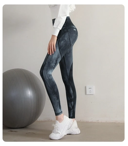 Detail of high waisted tie-dye yoga pants featuring a scrunch butt lift and smoky pattern