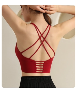 Detail of red sports bra featuring multi-strap cross back and horizontal cutout design
