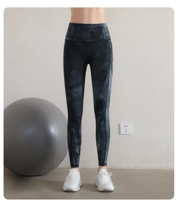 Detail of high-waisted tie-dye yoga pants with marble pattern and slimming fit effect