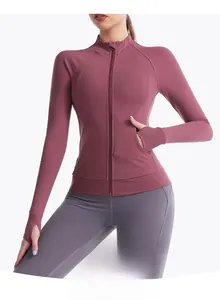 Detail of slim-fit dusty pink yoga jacket featuring high neck zipper and thumbhole cuffs