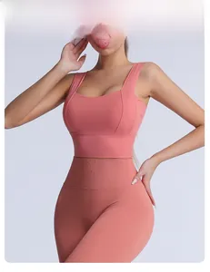 Detail view of coral pink high-waisted yoga leggings and square neck sports bra set