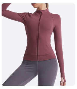 Detail view of pink slim fit yoga jacket featuring stand collar and thumbhole cuffs