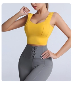 Detail of high-waist yoga leggings with criss-cross waist ties and side pocket in grey