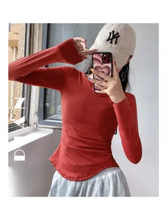 Detail of red slim-fit V-neck yoga top with side ruching and curved hem for women