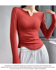 Detail view of V-neck stretchy long sleeve yoga top with flattering side ruching and curved hem