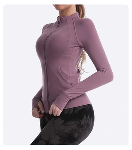 Detailed view of slim fit yoga jacket with stand collar and thumbholes in dusty rose