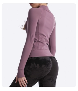 Detail showing high-waist tie-dye yoga leggings with slim fit pink long sleeve jacket