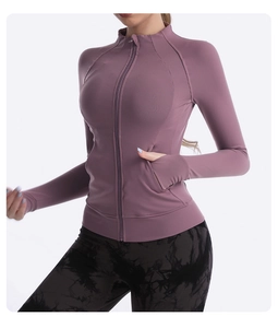 Detail of slim-fit yoga jacket sleeve featuring thumbhole cuffs and lilac purple fabric