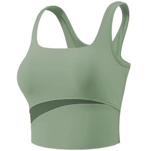 Detailed view of green sports bra with wide straps and side mesh cutout design