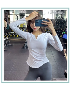 Detail of white V-neck fitness top with built-in padding and curved hem design
