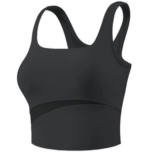 Close-up of black sports bra featuring asymmetrical mesh patchwork and wide shoulder straps