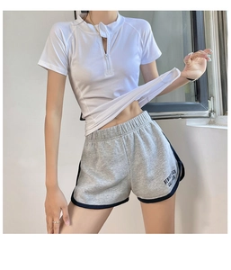 Close-up of sporty white half-zip t-shirt and grey shorts with Newport Beach text