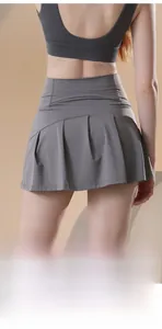 Detail of high-waisted pleated gray sports skort featuring moisture-wicking fabric for gym