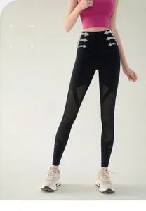 Detail of high-waisted yoga leggings featuring breathable mesh panels and elastic fabric