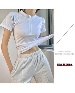 Detail of white slim fit half-zip sports t-shirt and grey drawstring jogger pants