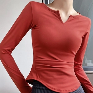 Women's V-neck slim fit yoga top with ruched waist and built-in pads in rust red