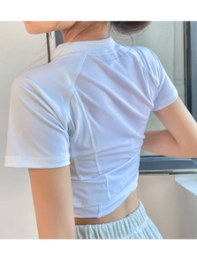 Close-up of women's white quick-dry sports top with breathable mesh back panel detail