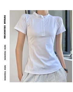Detail of white yoga top featuring half-zip stand collar and breathable stretch fabric