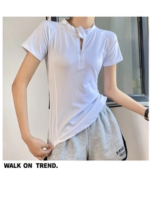 Close-up of a white slim-fit sports T-shirt with high collar and quarter zip detail