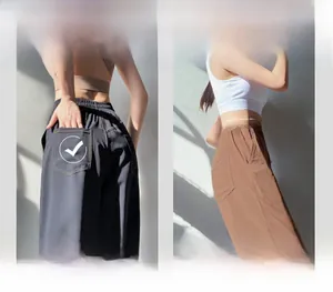 Detail of high waisted sports pants with elastic waistband and contrast stitching pockets
