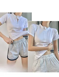 Detail of white half-zip yoga t-shirt and grey drawstring shorts on female model