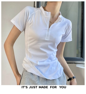 Detail of white slim-fit yoga top featuring half-zipper collar and breathable fabric