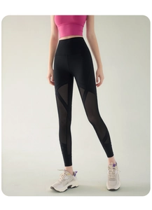 Detail view of high waisted black leggings with breathable side mesh patchwork panels