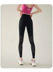 Detail view showing transparent mesh paneling on high-waisted black yoga leggings