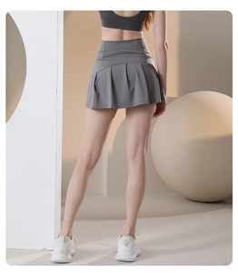 Rear view of high-waist charcoal gray pleated tennis skirt with quick-dry athletic fabric