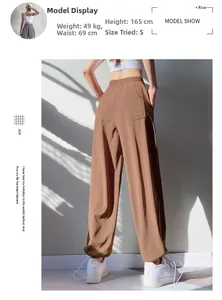 Detail view of high waist loose workout joggers with dual rear patch pockets in brown