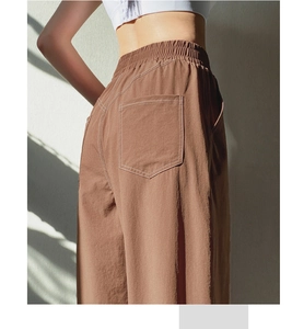 Detail of high waist brown yoga pants with contrast stitching and elastic waistband